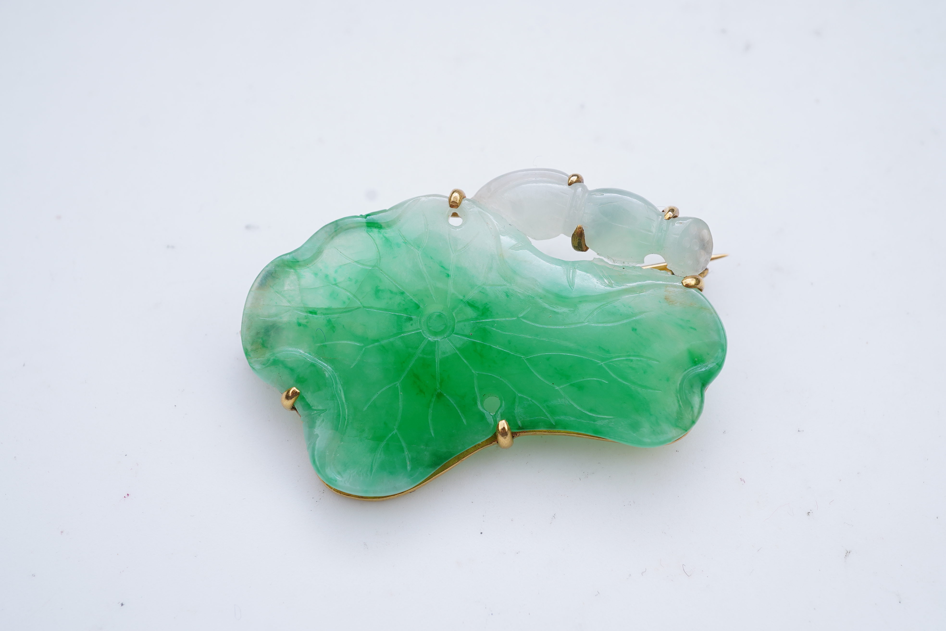 A gold and jadeite brooch
